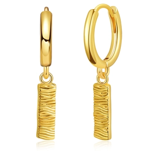 Macro view of gold hoop earrings featuring rectangular pendants with embossed textures