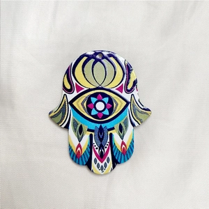 Detailed view of colorful acrylic Hamsa Hand charms with intricate geometric eye patterns