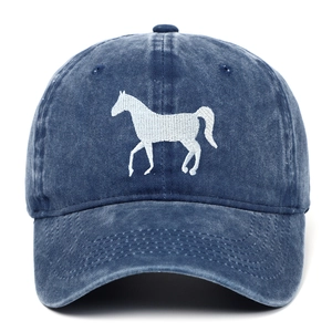 Detailed macro view of the white horse embroidery on a washed navy cotton baseball cap