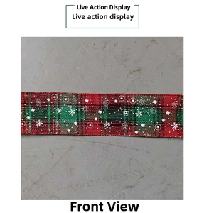 Detail of red and green plaid Christmas ribbon with white snowflake patterns and burlap texture