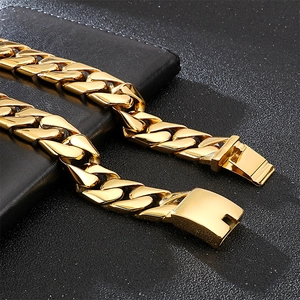 Macro shot of gold-plated Cuban chain necklace with a secure square clasp