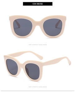 Close-up of beige round cat eye sunglasses frame with premium dark grey lenses