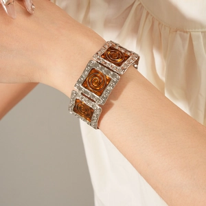 Detailed shot of vintage silver bracelet with orange enamel spiral square links on wrist