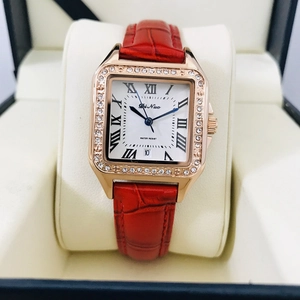 Close-up of square rose gold watch with sparkling crystals and red leather strap
