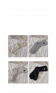 Detailed embroidery of cat face on textured crew socks in four versatile colors