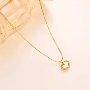 Close-up of golden titanium steel heart necklace with white shell inlay and O-chain