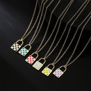 Gold chain necklaces with checkered lock pendants in multiple colors on black background