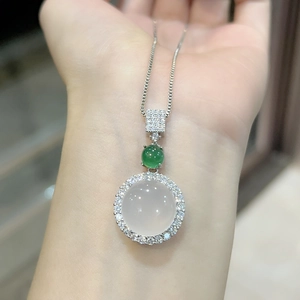 Detail of pink chalcedony pendant necklace with green stone and diamonds on model