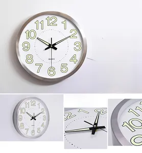 Detail of 12-inch wall clock featuring brushed metal frame and glowing luminous numerals