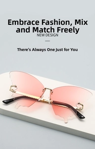 Detail of butterfly rimless sunglasses with pink gradient lenses and golden wavy temples