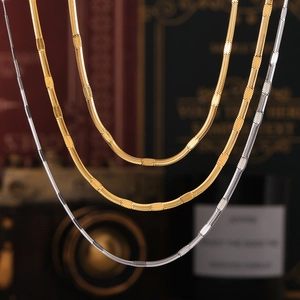Flat blade snake chain necklaces in gold and silver finish with high polished metal texture