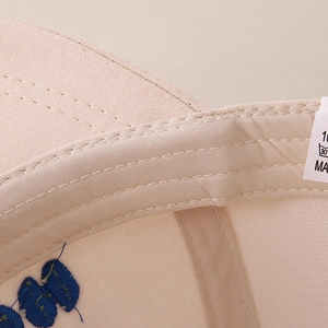 Detail view of reinforced stitching and inner lining on kids baseball cap