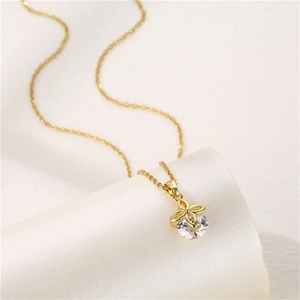Elegant gold four-leaf clover necklace with sparkling cubic zirconia on a white background