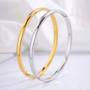 Polished titanium steel bangles in gold and silver finish with hinge closure