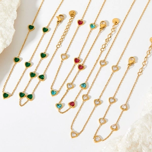 Golden heart necklace set with colorful zircon stones in emerald, ruby, and blue