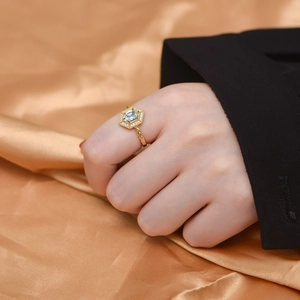 Close-up of S925 silver ring with oval sky blue topaz on gold silk background