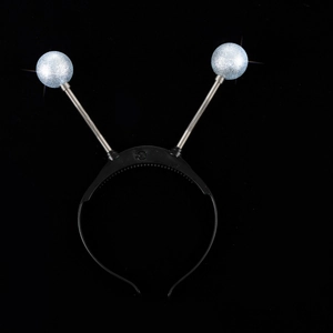 Detail of glowing alien eyeball headband with silver springs and LED power switch