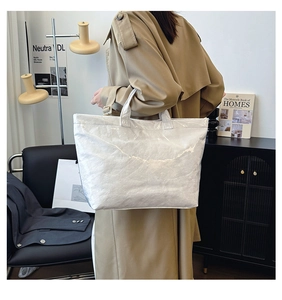 Silver DuPont paper tote bag with metallic texture shown in a modern lifestyle setting