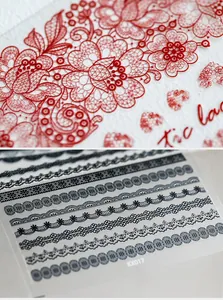 Macro shot of KX017 nail art stickers showing red floral patterns and black lace details