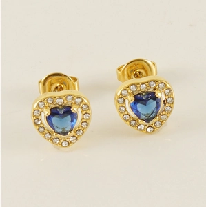 Close-up of gold heart stud earrings with blue gemstone and cubic zirconia halo