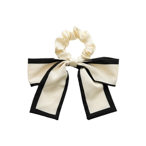 Elegant beige bow scrunchie with black trim for ponytail styling in French style