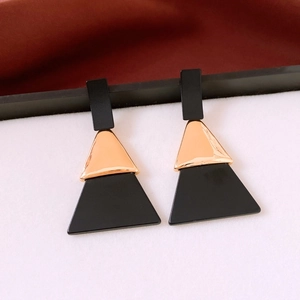 Detail of geometric acrylic triangle drop earrings with elegant black and gold finish