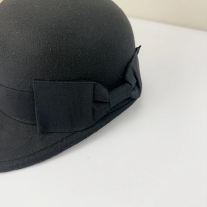 Detail of wool felt equestrian hat showing side bow ribbon and premium texture