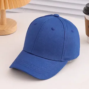 Detail of royal blue cotton baseball cap featuring six-panel construction and eyelets