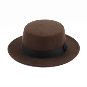 Detail view of brown wool felt boater hat with black ribbon band on white background