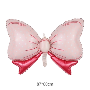 Pink polka dot bow foil balloon for baby showers measuring 87x60cm on white background