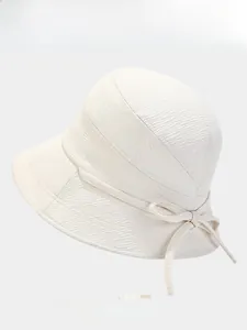 Detail of cream waffle texture bucket hat with a bow and multi-color options