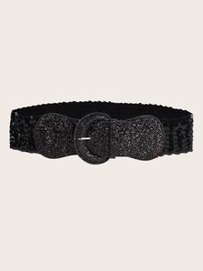 Close-up of wide black sequin elastic belt with a round glittery buckle for dresses