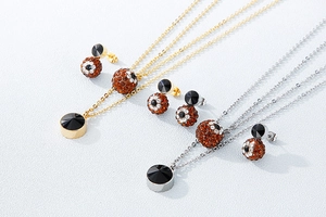 Detail of stainless steel jewelry sets with gold and silver chains and colorful crystals