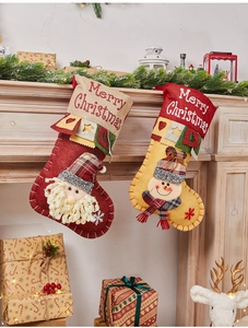 Set of felt Christmas stockings with 3D Santa and Snowman hanging on a wooden mantel