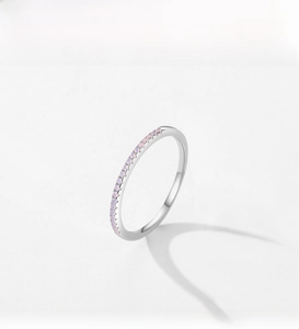 Detailed view of a slim S925 silver ring set with delicate round pink opal stones