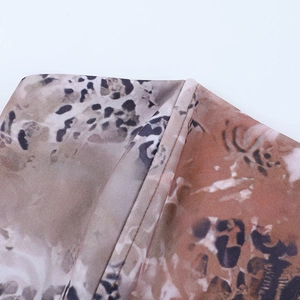 Macro view of leopard print fabric showing detailed texture and stitching for women's tops