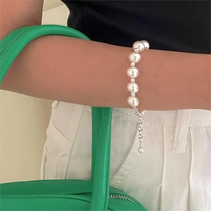 Elegant 925 sterling silver pearl bracelet with adjustable chain on woman's wrist