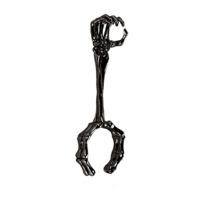Macro shot of gothic skull hand cigarette holder ring in gunmetal finish metal
