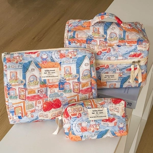 Detailed set of three quilted cotton cosmetic bags with cartoon bunny and house patterns