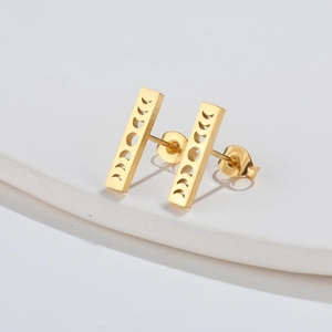 Macro shot of gold-plated stainless steel rectangular earrings with moon phase cutout