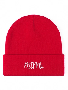 Close-up of a red knitted beanie featuring white Mimi letter embroidery on the cuff