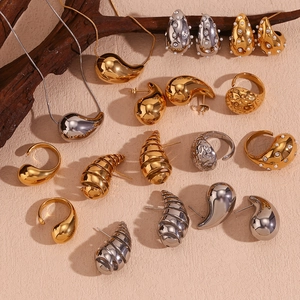 Polished 18K gold and silver teardrop earrings with matching necklaces and rings