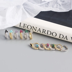 Macro detail of S925 sterling silver hoop earrings with colorful zircon floral clusters
