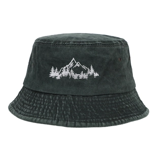 Detailed close-up of mountain forest embroidery on washed cotton bucket hat