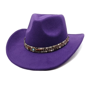 Detail of purple wool felt fedora with check band and blue evil eye pendant ornament