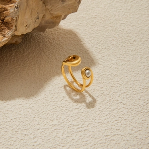 Detail of 18K gold stainless steel open ring featuring a white pearl on a paperclip band