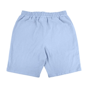 Rear view of light blue linen shorts featuring a comfortable elastic waistband and cotton fabric
