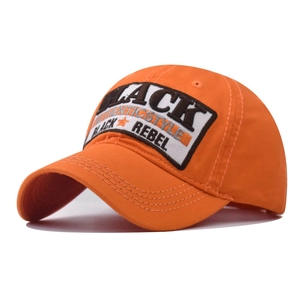 Close-up of orange cotton baseball cap with Black Rebel embroidery and curved brim
