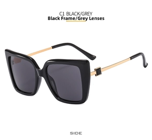 Detail of square oversized butterfly sunglasses with black frame and gold metal temples