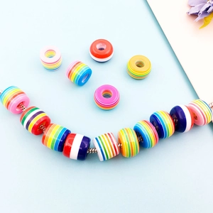 Detailed view of rainbow striped resin barrel beads for DIY jewelry making and bracelets